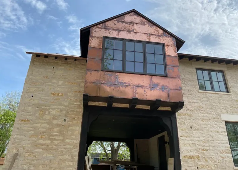 Copper metal panel facade on a stone building for Skylight Installation in Bensville